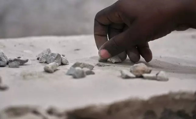 A Muslim pilgrim counts stones during the symbolic stoning of the devil, the last rite of the annual Hajj, in Mina near the holy city of Mecca, Saudi Arabia, Saturday, June 7, 2025. (AP Photo/Amr Nabil)