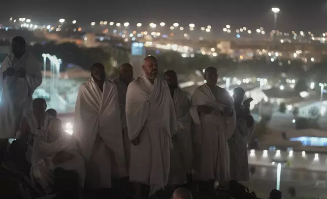 Muslim pilgrims pray on the rocky hill known as the Mountain of Mercy on the Plain of Arafat during the annual Hajj pilgrimage near the holy city of Mecca, Saudi Arabia, Thursday, June 5, 2025. (AP Photo/Amr Nabil)