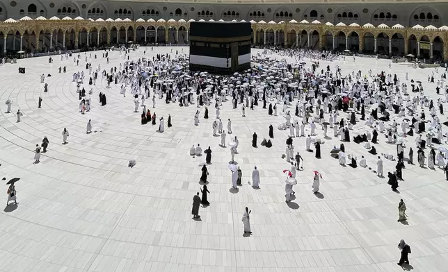 Muslim pilgrims walk around the Kaaba, the cubic building at the Grand Mosque, during the annual Hajj pilgrimage, in the Muslim holy city of Mecca, Saudi Arabia, Wednesday, June 4, 2025. (AP Photo/Amr Nabil)