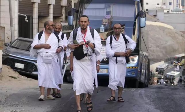 Pilgrims prepare to ride a bus from Mecca to Arafat, during the annual Hajj pilgrimage, in the Muslim holy city of Mecca, Saudi Arabia, Wednesday, June 4, 2025. (AP Photo/Amr Nabil)