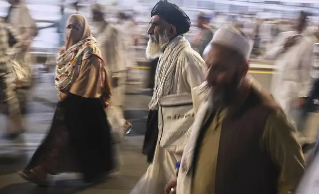 Muslim pilgrims leave the evening prayers outside the Grand Mosque, during the annual hajj pilgrimage in Mecca, Saudi Arabia, Monday, June 2, 2025. (AP Photo/Amr Nabi)