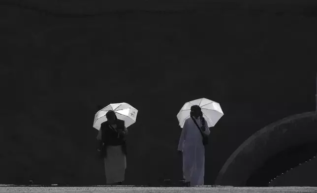 Muslim pilgrims walk to cast stones at pillars in the symbolic stoning of the devil, the last rite of the annual Hajj, in Mina near the holy city of Mecca, Saudi Arabia, Saturday, June 7, 2025. (AP Photo/Amr Nabil)