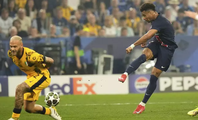 PSG's Desire Doue scores his side's second goal past Inter Milan's Federico Dimarco, left, during the Champions League final soccer match between Paris Saint-Germain and Inter Milan at the Allianz Arena in Munich, Germany, Saturday, May 31, 2025. (AP Photo/Luca Bruno)