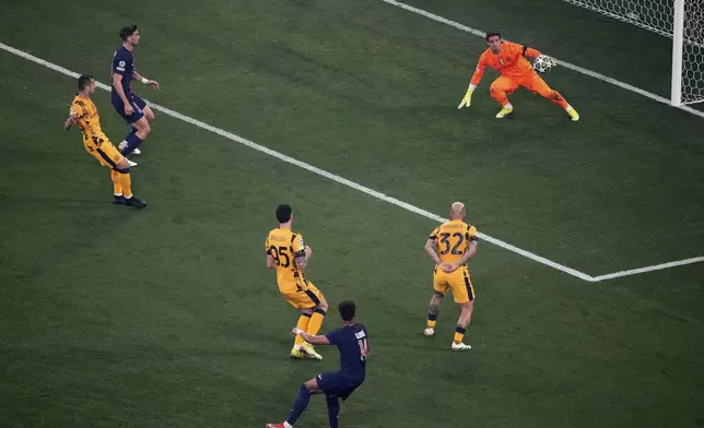 PSG's Desire Doue (14) scores his side's 2nd goal against Inter Milan during the Champions League final soccer match between Paris Saint-Germain and Inter Milan at the Allianz Arena in Munich, Germany, Saturday, May 31, 2025. (AP Photo/Michael Probst)