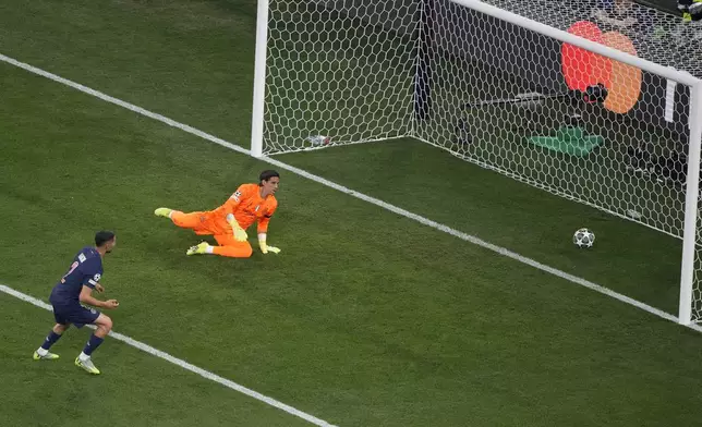 PSG's Achraf Hakimi, left, scores the opening goal against Inter Milan during the Champions League final soccer match between Paris Saint-Germain and Inter Milan at the Allianz Arena in Munich, Germany, Saturday, May 31, 2025. (AP Photo/Michael Probst)