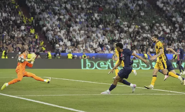 PSG's Senny Mayulu, right, scores his side's fifth goal during the Champions League final soccer match between Paris Saint-Germain and Inter Milan at the Allianz Arena in Munich, Germany, Saturday, May 31, 2025. (AP Photo/Martin Meissner)