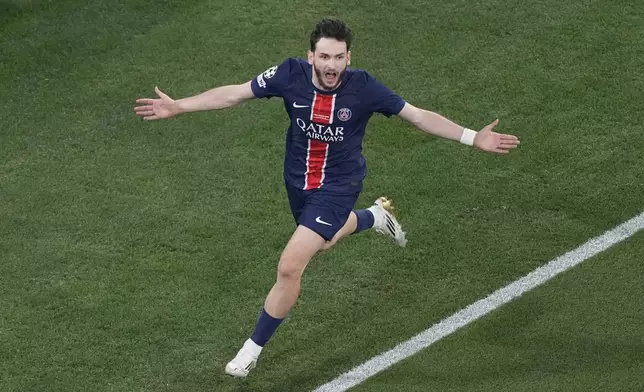 PSG¥s Khvicha Kvaratskhelia celebrates after scoring his side's fourth goal against Inter Milan during the Champions League final soccer match between Paris Saint-Germain and Inter Milan at the Allianz Arena in Munich, Germany, Saturday, May 31, 2025. (AP Photo/Michael Probst)