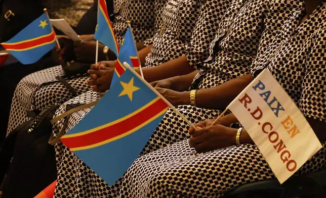 Faithful wait for the start of a beatification ceremony of Floribert Bwana Chui Bin Kositi, a Congolese man killed in 2007 for fighting corruption, in St. Paul Outside the Walls' Basilica, in Rome, Sunday, June 15, 2025. (AP Photo/Riccardo De Luca)