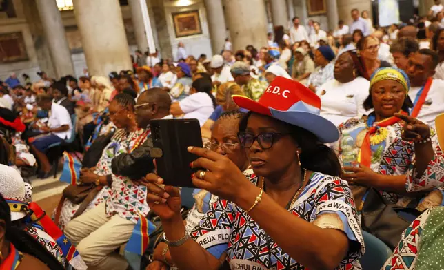 Faithful wait for the start of a beatification ceremony of Floribert Bwana Chui Bin Kositi, a Congolese man killed in 2007 for fighting corruption, in St. Paul Outside the Walls' Basilica, in Rome, Sunday, June 15, 2025. (AP Photo/Riccardo De Luca)