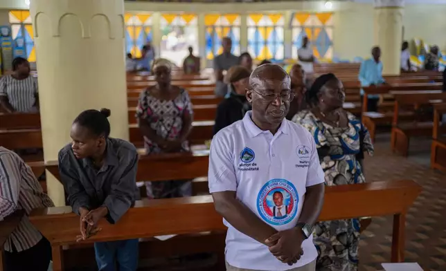 A man wears a T-shirt with a portrait of Floribert Bwana Chui Bin Kositi, during a mass service in his honour at a catholic church in Goma, Democratic Republic of Congo, Saturday, June 14, 2025. (AP Photo/Moses Sawasawa)