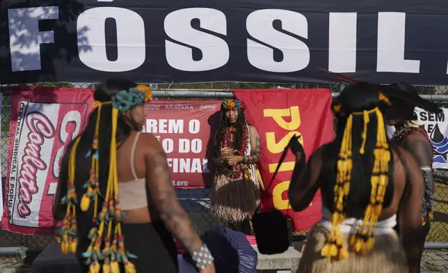Indigenous women attend a protest against the auction of dozens of oil blocks, including blocks near the mouth of the Amazon River, in Rio de Janeiro, Tuesday, June 17, 2025. (AP Photo/Silvia Izquierdo