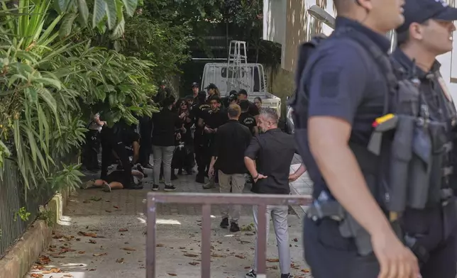 People are detained by police officers as they try to gather during the annual LGBTQ+ Pride March, in Istanbul, Turkey, Sunday, June 29, 2025. (AP Photo/Dilara Acikgoz)