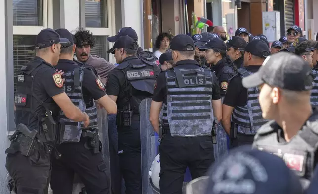 A person is detained by Turkish police officers during the annual LGBTQ+ Pride March, in Istanbul, Turkey, Sunday, June 29, 2025. (AP Photo/Dilara Acikgoz)