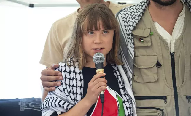 Climate activist Greta Thunberg with other activists from a human rights organization meets with journalists in Catania, Italy, Sunday, June 1, 2025, ahead of their departure for the Mideast. (AP Photo/Salvatore Cavalli)