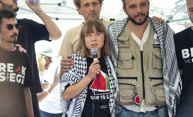 Climate activist Greta Thunberg flanked by Thiago Avila from a human rights organization meets with journalists in Catania, Italy, Sunday, June 1, 2025, ahead of their departure for the Mideast. (AP Photo/Salvatore Cavalli)
