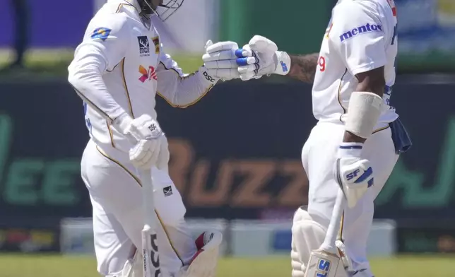 Sri Lanka's Lahiru Udara, right, and Pathum Nissanka bump fists after scoring runs during day three of the first cricket test match between Sri Lanka and Bangladesh in Galle, Sri Lanka, Thursday, June 19, 2025. (AP Photo/Eranga Jayawardena)