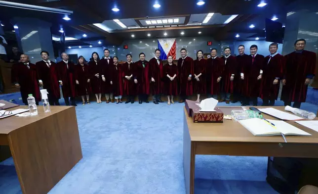 In this photo provided by the Senate Social Media Unit, Philippine Senators pose before they take oath as jurors in the impeachment trial of Vice President Sara Duterte at the Philippine Senate in Pasay city, Philippines on Tuesday June 10, 2025. (Senate Social Media Unit, Voltaire Fernandez Domingo via AP)