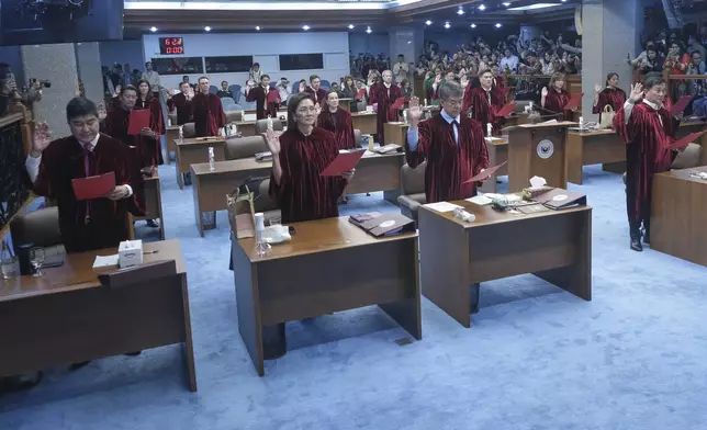 In this photo provided by the Senate Social Media Unit, Philippine Senators take oath as jurors in the impeachment trial of Vice President Sara Duterte at the Philippine Senate in Pasay city, Philippines on Tuesday June 10, 2025. (Senate Social Media Unit, Voltaire Fernandez Domingo via AP)