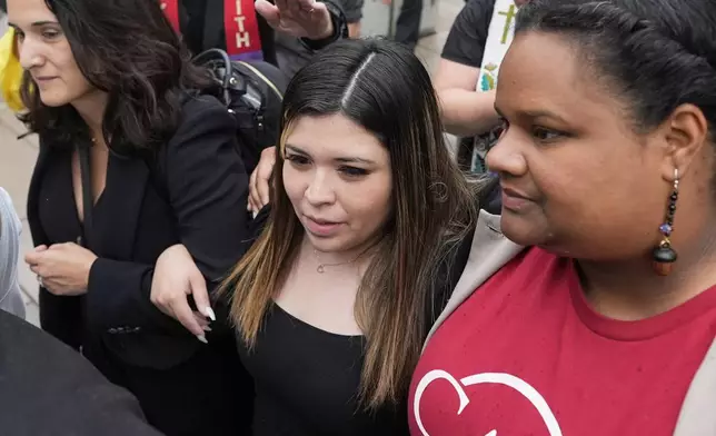 Jennifer Vasquez Sura, wife of Kilmar Abrego Garcia, center, is escorted out of the Federal Courthouse on Friday, June 13, 2025, in Nashville, Tenn. (AP Photo/George Walker IV)
