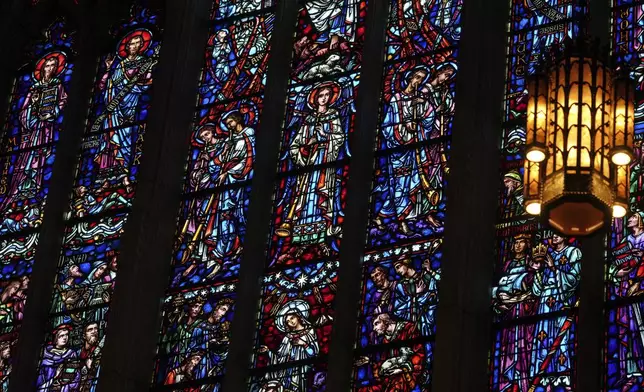 Stained glass windows at the Princeton University chapel are illuminated by sunlight in Princeton, N.J., on Thursday, May 15, 2025. (AP Photo/Luis Andres Henao)