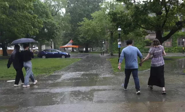 David Kim, a Catholic altar server, and his girlfriend, Savannah Nichols, walk on the Princeton University campus after attending a Mass at the school's chapel in Princeton, N.J., on Friday, May 16, 2025. (AP Photo/Luis Andres Henao)