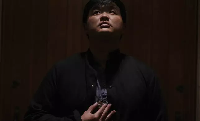 David Kim, a Catholic altar server, stands for a portrait before a Mass at the Princeton University chapel in Princeton, N.J., on Friday, May 16, 2025. (AP Photo/Luis Andres Henao)