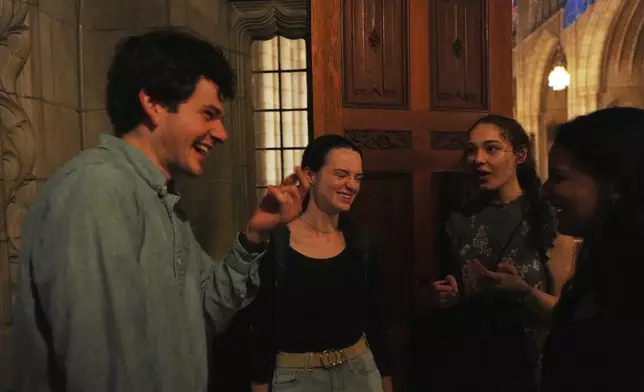 Members of the Aquinas Institute, Princeton University’s Catholic campus ministry, talk after attending a Mass at the school's chapel in Princeton, N.J., on Friday, May 16, 2025. (AP Photo/Luis Andres Henao)