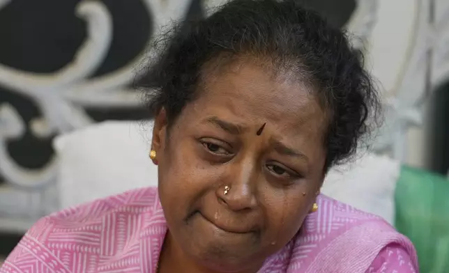A woman cries next to the body of 14-year-old Divyanshi Shivakumar, who lost her life in Wednesday's deadly stampede during celebrations outside a stadium for Royal Challengers Bengaluru, winners of the Indian Premier League, at her residence ahead of her last rites in Bengaluru, India, Thursday, June 5, 2025. (AP Photo/Aijaz Rahi)