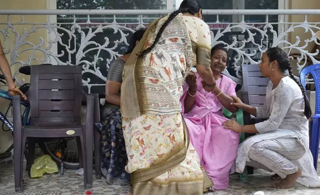Women console a wailing relative of 14-year-old Divyanshi Shivakumar, who lost her life in Wednesday's deadly stampede during celebrations outside a stadium for Royal Challengers Bengaluru, winners of the Indian Premier League, at her residence ahead of her last rites in Bengaluru, India, Thursday, June 5, 2025. (AP Photo/Aijaz Rahi)