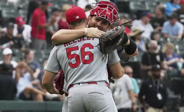 St. Louis Cardinals relief pitcher Ryan Helsley (56) celebrates with catcher Iván Herrera, right, after they defeated the Chicago White Sox in the first baseball game of a doubleheader Thursday, June 19, 2025. (AP Photo/Nam Y. Huh)