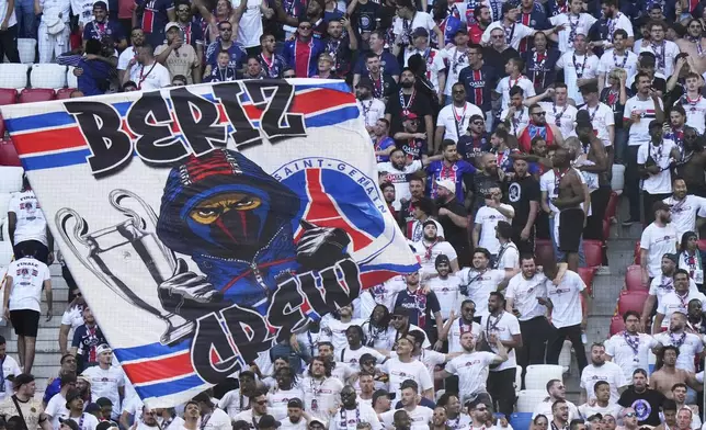 PSG fans wave flags on the stands ahead of the Champions League final soccer match between Paris Saint-Germain and Inter Milan at the Allianz Arena in Munich, Germany, Saturday, May 31, 2025. (AP Photo/Luca Bruno)