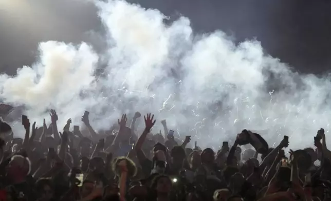 PSG supporters celebrate during the Champions League final soccer match between Paris Saint-Germain and Inter Milan, Saturday, May 31, 2025 at the Parc des Princes stadium in Paris. (AP Photo/Michel Euler)