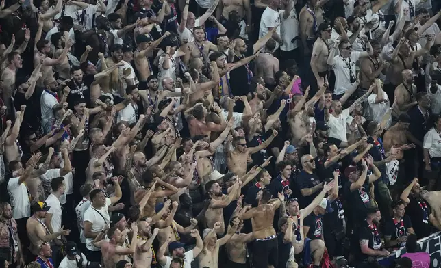 Fans of PSG cheer for their team during the Champions League final soccer match between Paris Saint-Germain and Inter Milan at the Allianz Arena in Munich, Germany, Saturday, May 31, 2025. (AP Photo/Michael Probst)