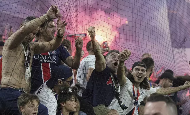 PSG fans celebrate after PSG's Achraf Hakimi scores his side's opening goal during the Champions League final soccer match between Paris Saint-Germain and Inter Milan at the Allianz Arena in Munich, Germany, Saturday, May 31, 2025. (AP Photo/Martin Meissner)