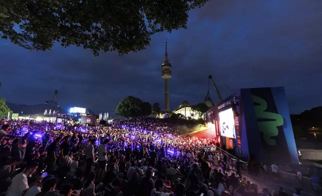 Fans watch a broadcast of the Champions League final soccer match between Paris Saint-Germain and Inter Milan at the Fan Zone in Olympic Park, Saturday, May 31, 2025, in Munich, Germany. (Matthias Balk/dpa via AP)
