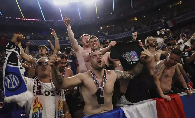 PSG fans celebrate during the Champions League final soccer match between Paris Saint-Germain and Inter Milan at the Allianz Arena in Munich, Germany, Saturday, May 31, 2025. (AP Photo/Alexandra Beier)