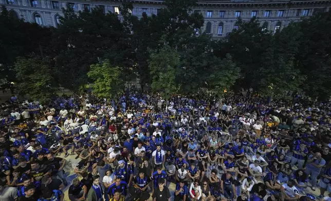 Inter Milan fans watch on a screen the Champions League final soccer match between Paris Saint-Germain and Inter Milan in open pub in downtown Milan, Italy, Saturday, May 31, 2025. (AP Photo/Antonio Calanni)