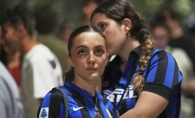Inter Milan fans react as they watch their team play PSG in the Champions League final soccer match in open pub in Milan, Italy, Saturday, May 31, 2025. (AP Photo/Antonio Calanni)