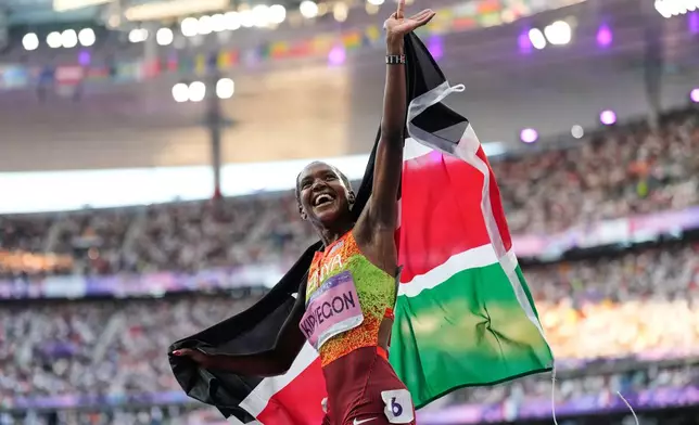 FILE - Faith Kipyegon, of Kenya, celebrates after winning the gold medal in the women's 1500 meters final at the 2024 Summer Olympics, Saturday, Aug. 10, 2024, in Saint-Denis, France. (AP Photo/Ashley Landis, File)