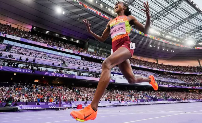 FILE - Faith Kipyegon, of Kenya, celebrates after winning the women's 1500-meter final at the 2024 Summer Olympics, Saturday, Aug. 10, 2024, in Saint-Denis, France.(AP Photo/David J. Phillip, File)