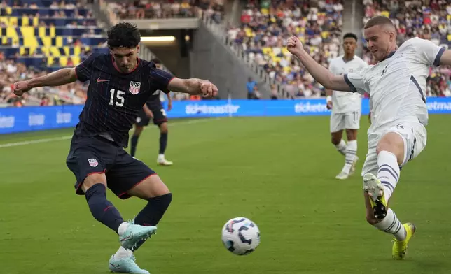 United States midfielder Johnny Cardoso (15) kicks the ball past Switzerland defender Nico Elvedi, right, during the first half of an international friendly soccer match Tuesday, June 10, 2025, in Nashville, Tenn. (AP Photo/George Walker IV)