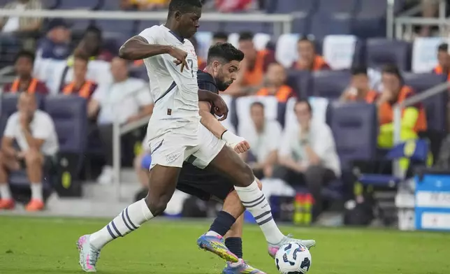 Switzerland forward Breel Embolo (7) kicks the ball away from United States forward Brian White, right, during the first half of an international friendly soccer match Tuesday, June 10, 2025, in Nashville, Tenn. (AP Photo/George Walker IV)