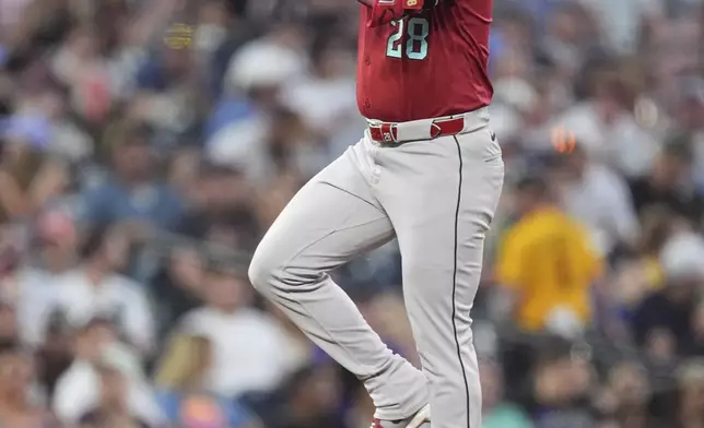 Arizona Diamondbacks' Eugenio Suárez gestures to the dugout as he circles the bases after hitting a two-run home run off Colorado Rockies relief pitcher Ryan Rolison in the sixth inning of a baseball game Friday, June 20, 2025, in Denver. (AP Photo/David Zalubowski)