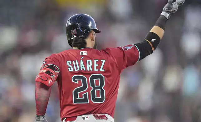 Arizona Diamondbacks' Eugenio Suárez gestures to the bullpen as he circles the bases after hitting a two-run home run off Colorado Rockies relief pitcher Ryan Rolison in the sixth inning of a baseball game Friday, June 20, 2025, in Denver. (AP Photo/David Zalubowski)
