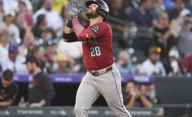Arizona Diamondbacks' Eugenio Suárez gestures as he circles the basses after hitting a solo home run off Colorado Rockies starting pitcher Austin Gomber in the fifth inning of a baseball game Friday, June 20, 2025, in Denver. (AP Photo/David Zalubowski)