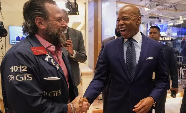 Trader Michael Pistillo, left, meets New York Mayor Eric Adams on the floor of the New York Stock Exchange after Adams was interviewed on CNBC, Friday, June 27, 2025. (AP Photo/Richard Drew)