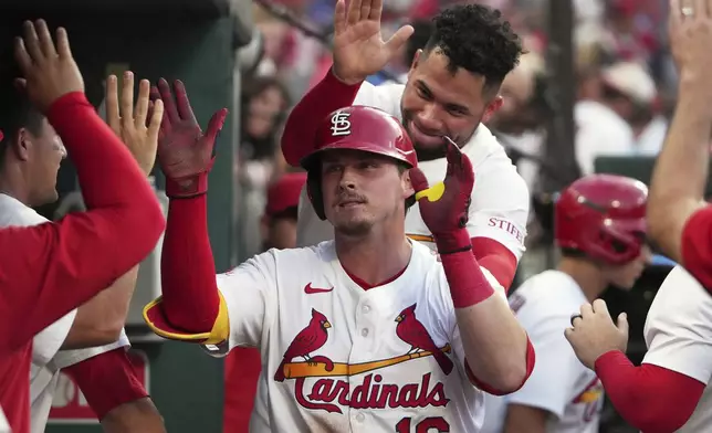 St. Louis Cardinals' Nolan Gorman (16) is congratulated by teammate Willson Contreras after hitting a solo home run during the fourth inning of a baseball game against the Chicago Cubs Tuesday, June 24, 2025, in St. Louis. (AP Photo/Jeff Roberson)