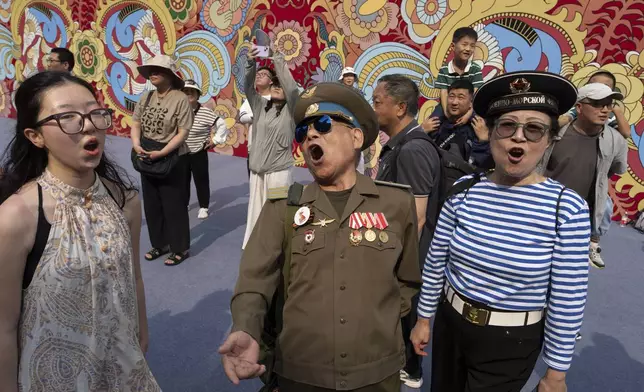 A Chinese veteran wearing an old Soviet style military uniform sings during an event promoting tourism to Moscow at the Wangfujing Shopping Street in Beijing, China, Thursday, June 12, 2025. (AP Photo/Ng Han Guan)