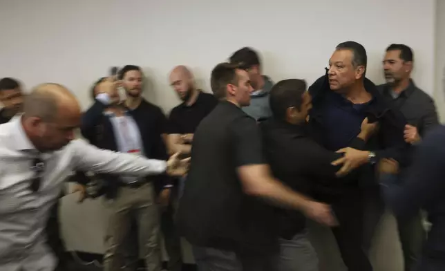 U.S. Sen. Alex Padilla, D-Calif., is pushed out of the room as Homeland Security Secretary Kristi Noem holds a news conference regarding the recent protests in Los Angeles on Thursday, June 12, 2025. (AP Photo/Etienne Laurent)