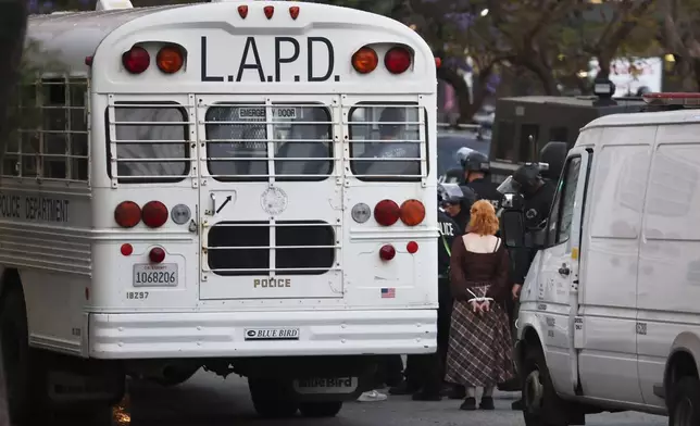 Protesters are loaded onto Los Angeles Police Department buses during a protest on Wednesday, June 11, 2025, in Los Angeles. (AP Photo/Ethan Swope)